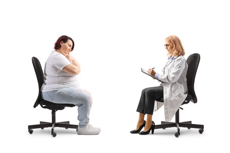 Overweight woman at a doctors appointment isolated on white backgroundの写真素材