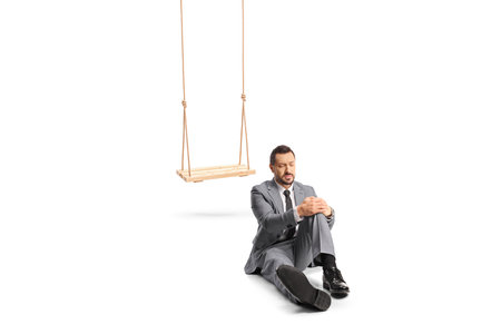 Adult man falling from a swing and holding his injured knee isolated on white backgrounddの写真素材
