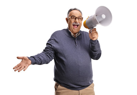 Mature man shouting and holding a megaphone isolated on white backgroundの写真素材