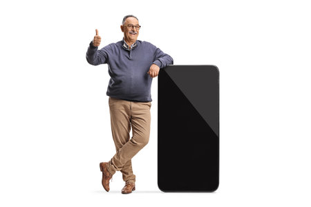 Mature man and a big smartphone with empty black screen isolated on white backgroundの写真素材