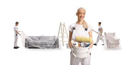 House painters covering furniture with a plastic drop cloth isolated on white backgroundの写真素材