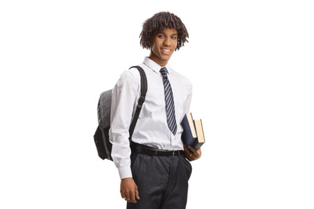 African american male student in a college uniform holding books isolated on white backgroundの写真素材