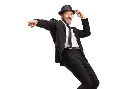 Showman in a suit and hat dancing and pointing isolated on white backgroundの写真素材
