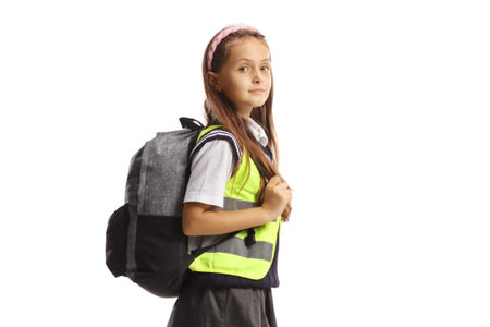 Schoolgirl wearing a safety reflective vest isolated on white backgroundの写真素材