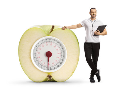 Sports coach with a weight scale isolated on white backgroundの写真素材