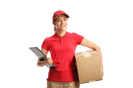 Female delivery worker holding a clipboard and a box isolated on white backgroundの写真素材
