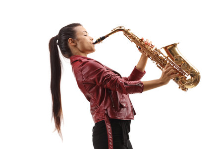 Young female saxophonist with long black hair playing sax isolated on white backgroundの写真素材