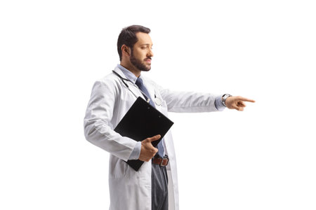 Doctor standing and pointing isolated on white backgroundの写真素材