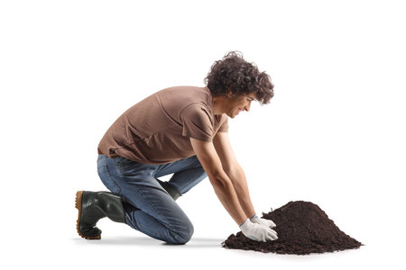 Man working with soil, nature care concept isolated on white backgroundの写真素材