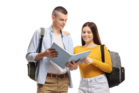Students with backpacks standing and reading a book isolated on white backgroundの写真素材