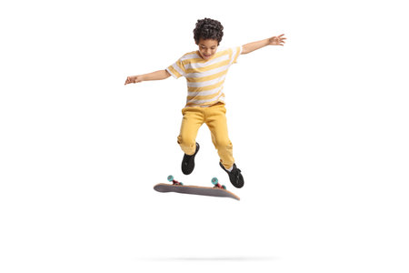 Happy boy jumping with a skateboard isolated on white backgroundの写真素材