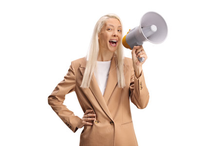 Cheerful woman shouting with a megaphone isolated on white backgroundの写真素材