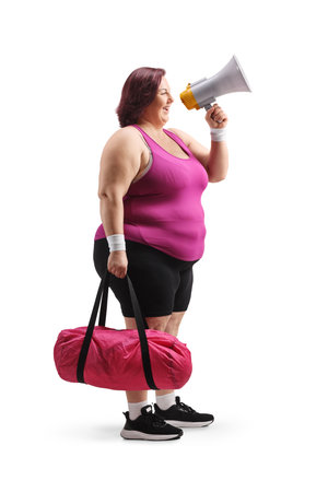 Woman in sportswear holding a megaphone isolated on white backgroundの写真素材