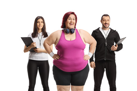 Overweight woman with sports coaches, weight loss concept isolated on white backgroundの写真素材