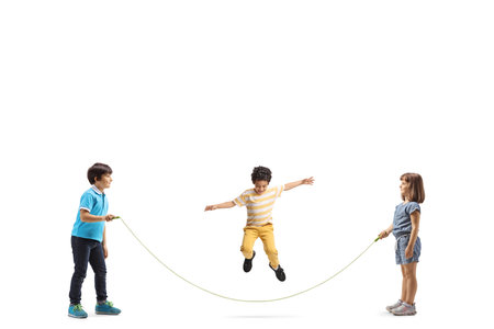Children playing skipping rope isolated on white backgroundの写真素材