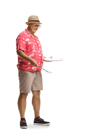 Mature man holding a fork and an empty plate isolated on white backgroundの写真素材