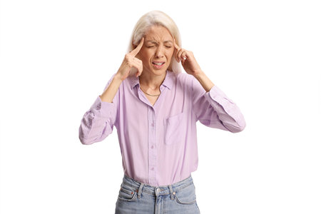Young woman suffering from headache isolated on white backgroundの写真素材