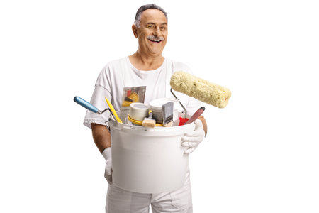 Painter carrying a bucket with brushes isolated on white backgroundの写真素材