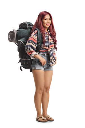 Young female traveler with a backpack isolated on white backgroundの写真素材
