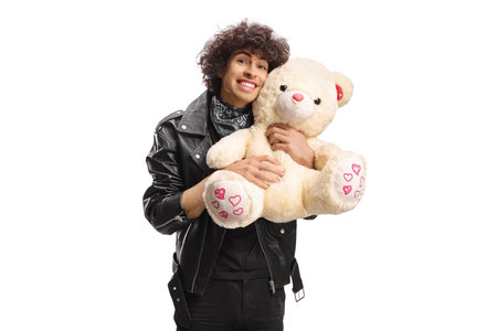Young man hugging a teddy bear isolated on white backgroundの写真素材