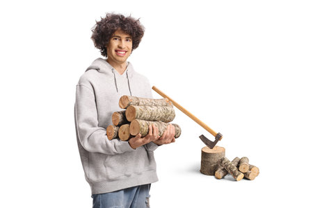 Young man cutting firewood isolated on white backgroundの写真素材