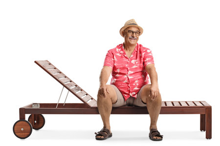 Mature man on a holiday sitting on a lounge chair isolated on white backgroundの写真素材