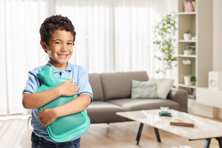 Boy holding a hot bottle body warmerの写真素材