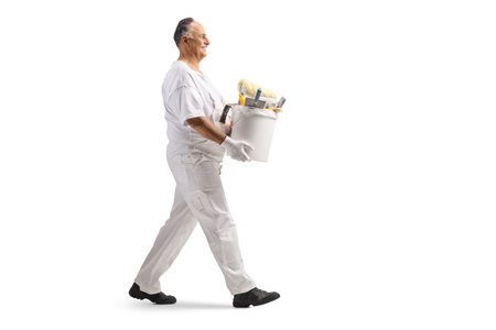 Painter walking and carrying a bucket isolated on white backgroundの写真素材