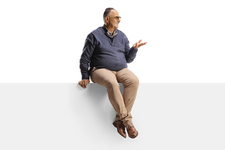 Full length shot of a man seated on a panel talking and gesturing with hand isolated on white backgroundの写真素材