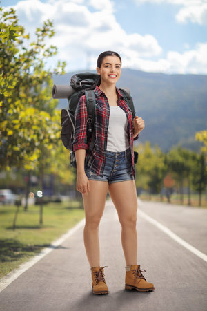 Female hiker with a backpack standing in a parkの写真素材