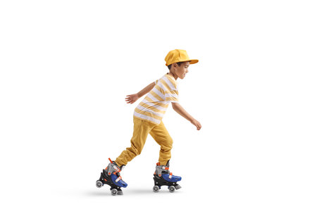 Full length profile shot of a boy riding roller skates isolated on white background