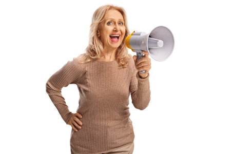 Middle aged woman speaking with a megaphone isolated on white backgroundの写真素材
