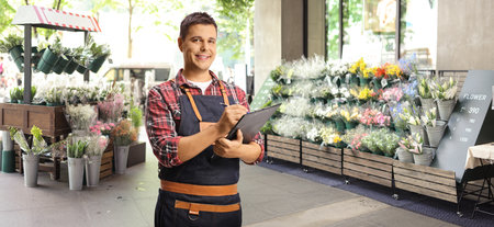 Florsit writing a document in a flower shopの写真素材