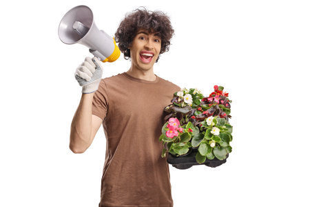 Male gardener holding plants and a megaphone isolated on white backgroundの写真素材