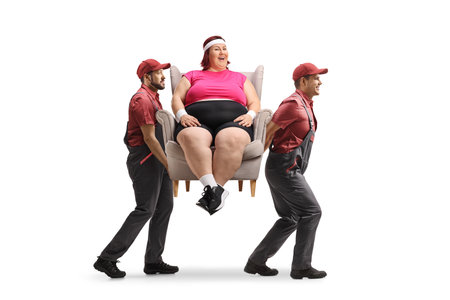 Movers carrying a corpulent woman in an armchair isolated on white backgroundの写真素材