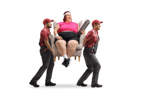Movers carrying a woman seated in an armchair isolated on white backgroundの写真素材