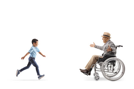 Kid running towards a senior man in a wheelchair isolated on white background