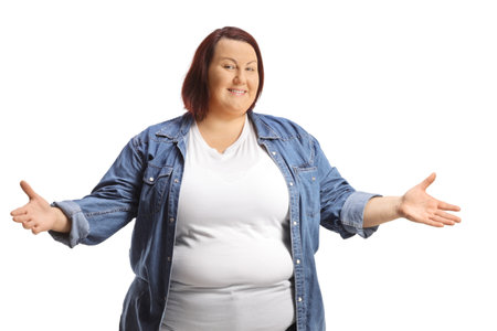 Overweight young woman standing and gesturing with hands isolated on white backgroundの写真素材