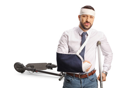 Traffic accident, injured electric scooter driver isolated on white backgroundの写真素材
