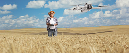 Farmer on a wheat field flying a drone, modern agriculture  technology concept