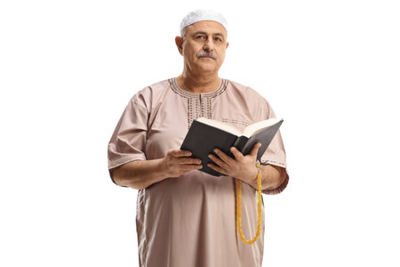 Mature muslim man reading a book isolated on white backgroundの写真素材