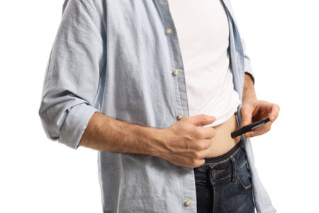 Person injecting insulin pen in the abdomen isolated on white backgroundの写真素材