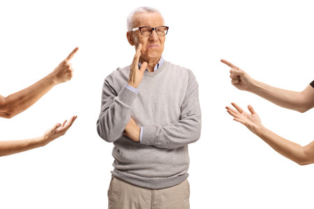 Fingers reprimanding an elderly man isolated on white backgroundの写真素材