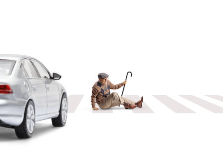 Elderly man sitting on a zebra crossing isolated on white backgroundの写真素材