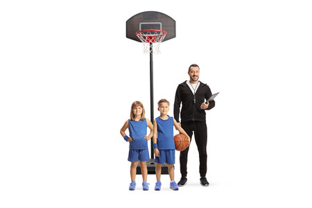 Coach with a girl and boy at basketball training isolated on white backgroundの写真素材