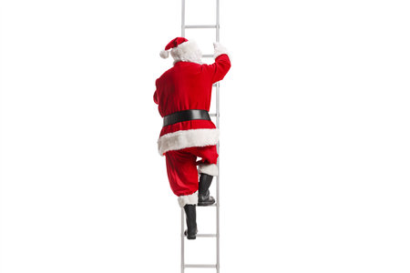 Rear view shot of Santa Claus climbing a ladder isolated on white backgroundの写真素材