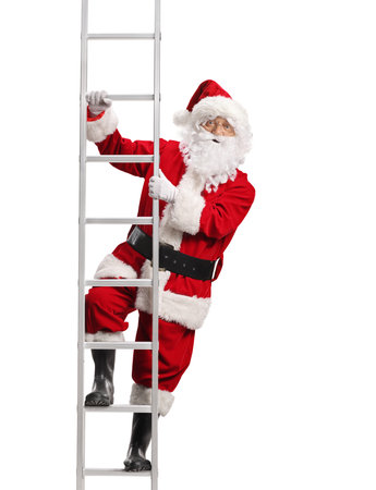 Santa Claus climbing a ladder and looking at camera isolated on white backgroundの写真素材