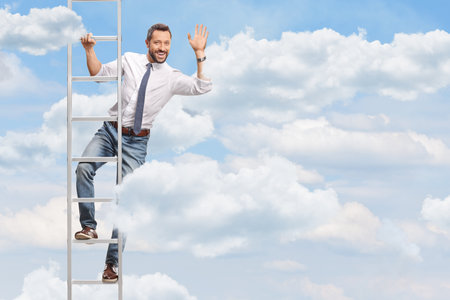 Man climbing a ladder to the clouds and wavingの写真素材