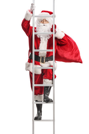 Santa Claus climbing a ladder and carrying sack on his back isolated on white backgroundの写真素材