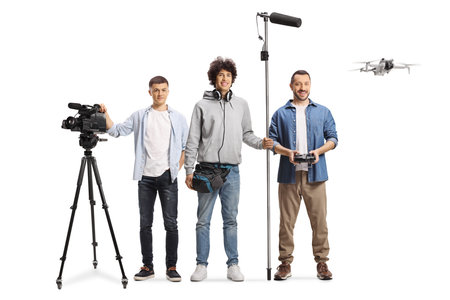 Camera department workers with a drone and equipment isolated on white backgroundの写真素材